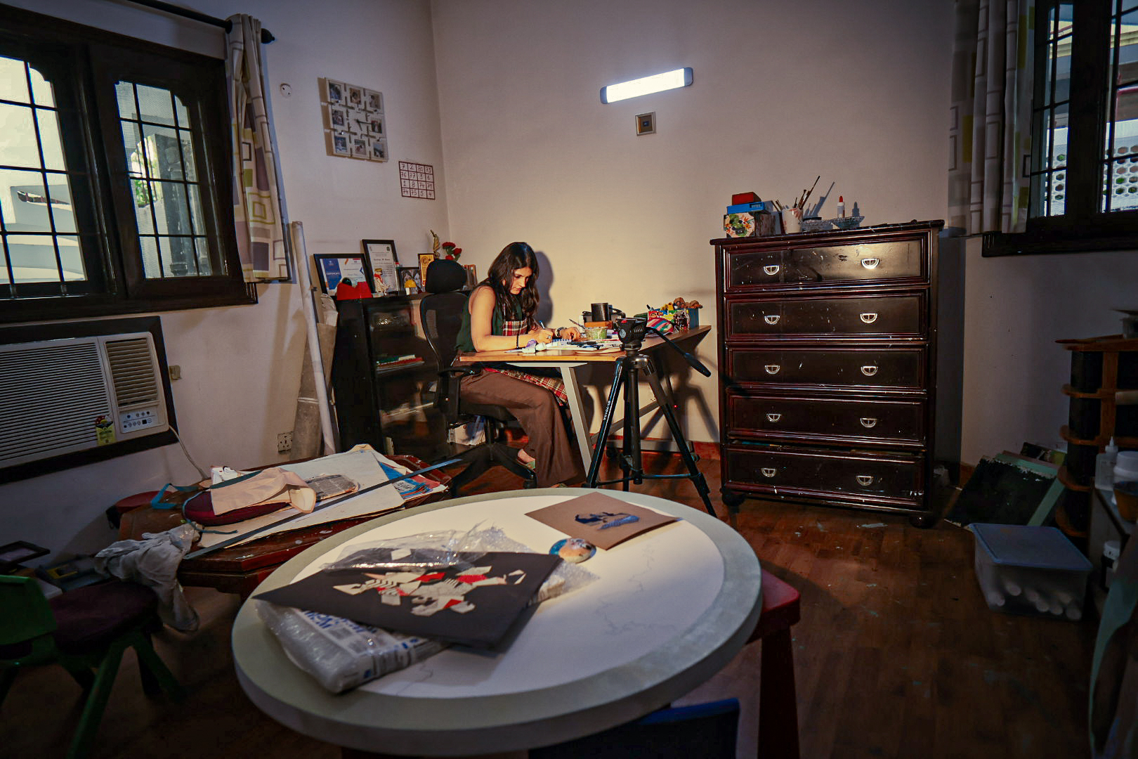 A view across the studio with a circular artwork in the foreground
