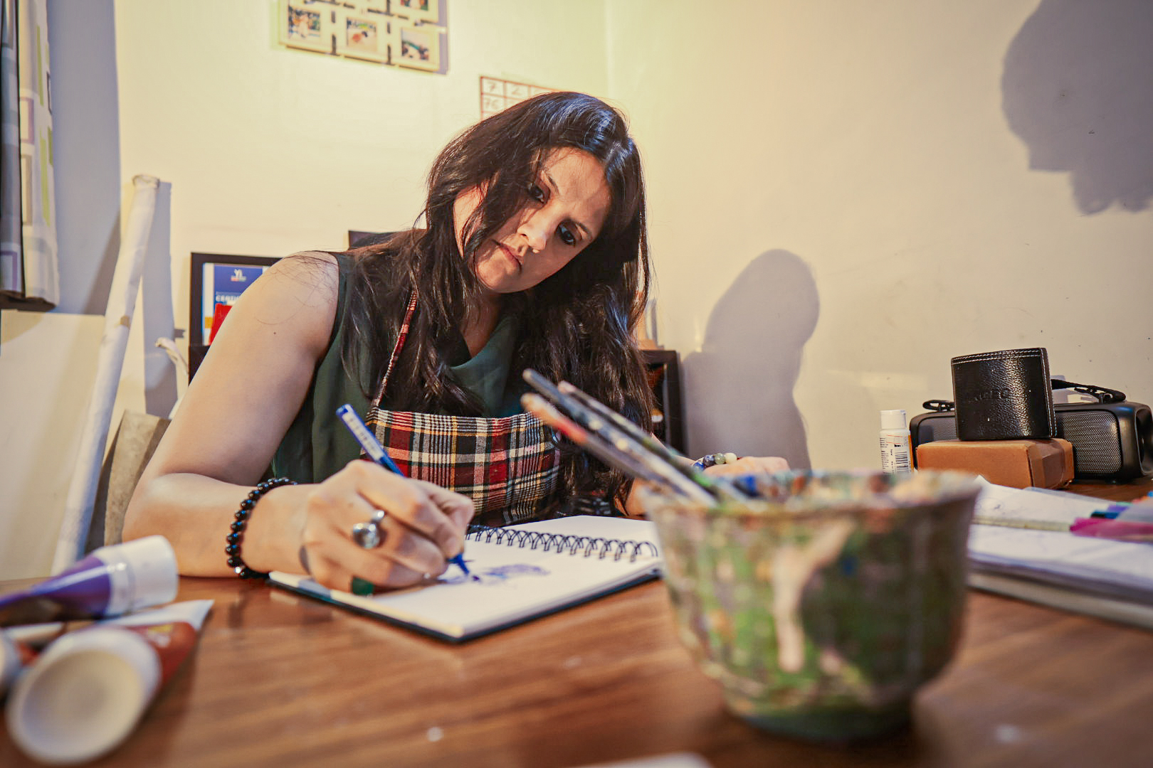 Shivani Garg drawing in a sketchbook at her desk