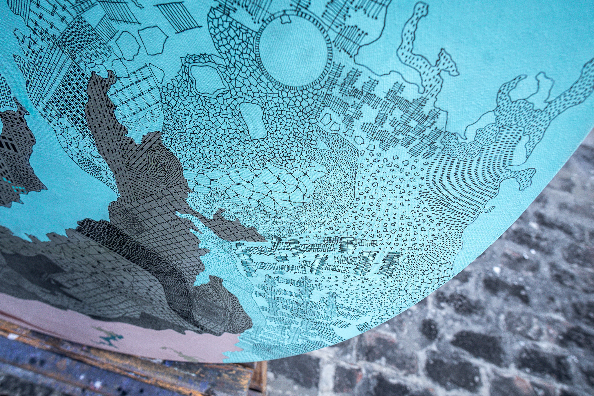 Close-up of turquoise shapes and fine lines on an artwork