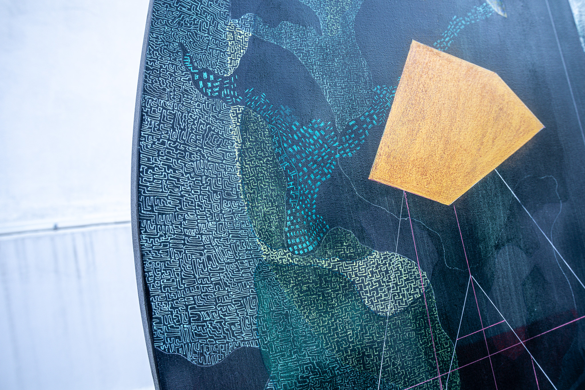 Yellow geometric form against a textured blue surface