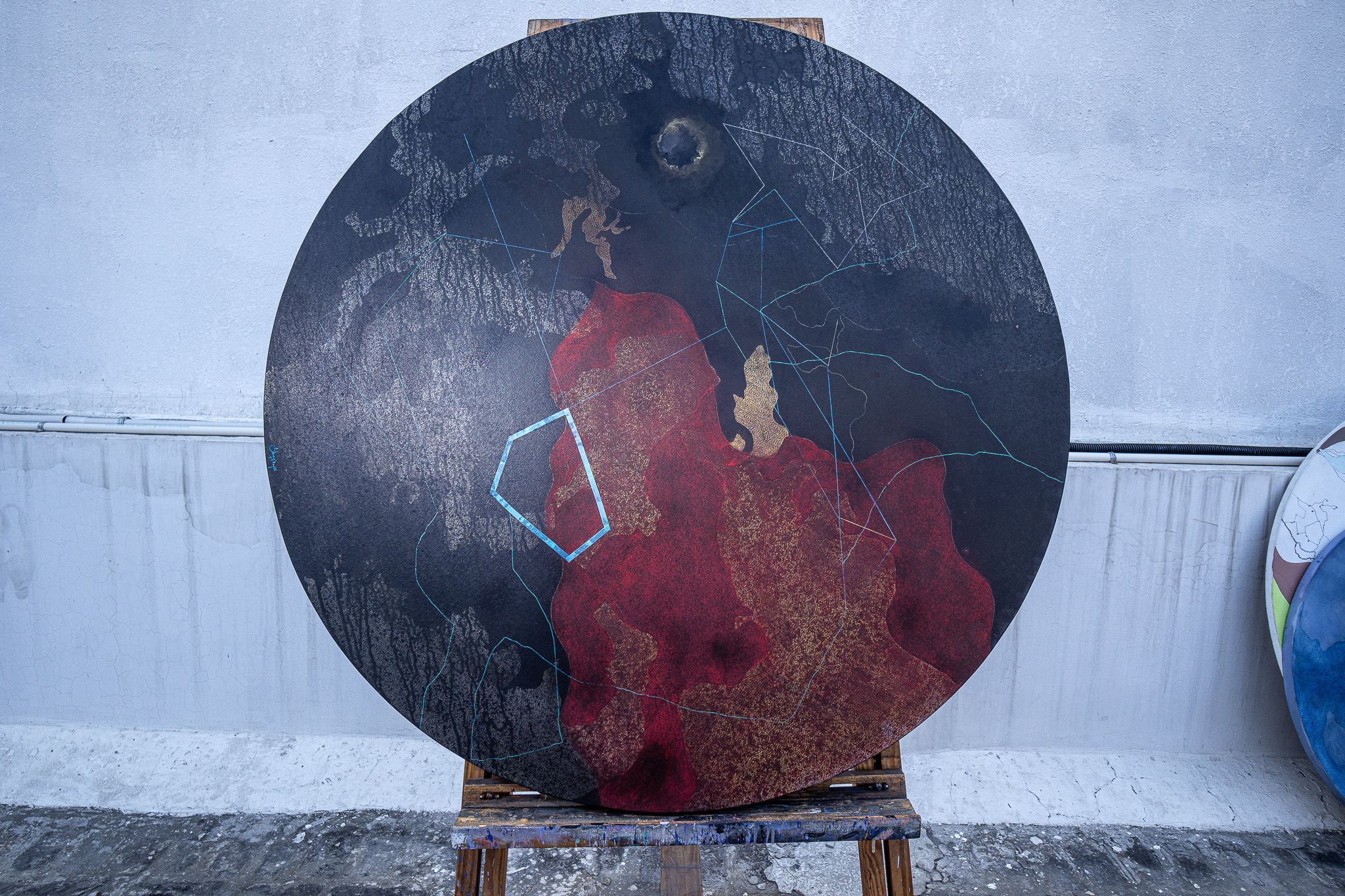 Charcoal and red circular work — full view